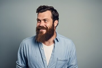 Portrait of a bearded hipster man in a blue shirt.