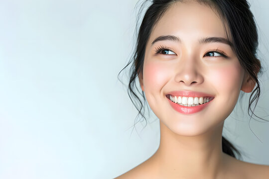 Young Asian woman close up portrait. Model woman laughing and smiling. Healthy face skin care beauty, skincare cosmetics, dental.