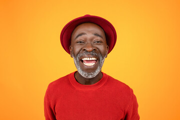 Happy excited senior african american man in hat and red clothes, with open mouth
