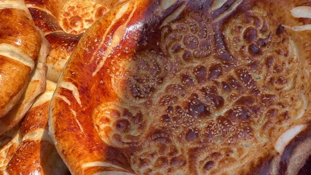Tortillas on the market in Samarkand, Uzbekistan - June 29, 2023: Goods and traders at the Oriental Bazaar in Uzbekistan. Siab Bazaar is the largest and oldest bazaar in Samarkand. 4K