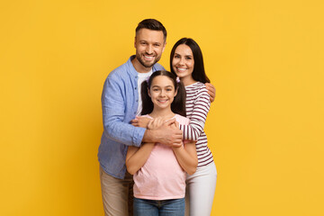 Closeup Portrait Of Happy Family Of Three With Teen Daughter