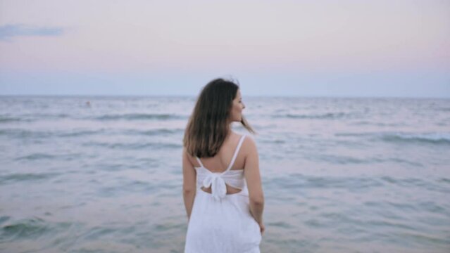 Brunette Woman In White Dress On The Beach, Sea Waves at Sunset 4k