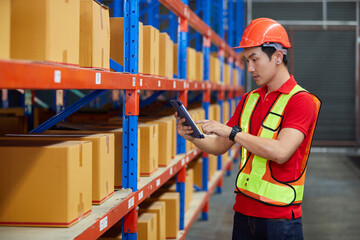 worker working on tablet and checking product list in the warehouse storage