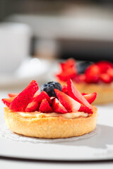 Delicious mini tart with strawberries and cream