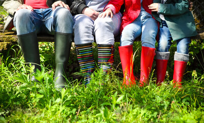 Happy family wearing colorful rain boots
