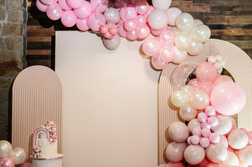 Arch decorated with pink, brown balloons. Cake is decorated bear figure, rainbow. Trendy baptism...