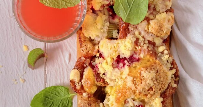 Top down view of summer rhubarb yeast cake with juice.