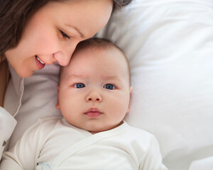 Portrait of mother and child laughing and playing