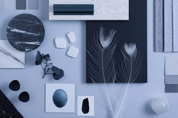 Creative flat lay composition in grey and black color palette with textile and paint samples, panels and tiles. Architect and interior designer moodboard. Top view. Copy space. Template.