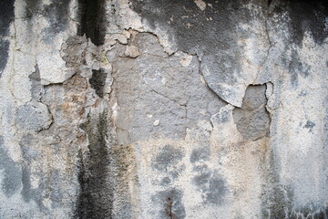 Cracked, peeled and damaged exterior wall plaster, gray, no people