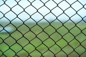 Chain link metal wire fence, close up shot, shallow depth of field, no people