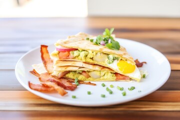 Fototapeta na wymiar breakfast quesadilla with egg and bacon inside