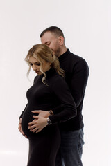 Happy family expecting a baby on a light background