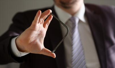 Man in suit and tie bend nail with arms closeup no limit energy easy problem solve issue superman help pressure concept