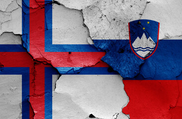 flags of Faroe Islands and Slovenia painted on cracked wall