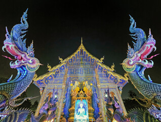Viharn and dragons at Wat Rong Suea Ten Blue temple, Chiang Rai, Thailand - 707755436