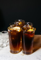 Iced Cola Drinks in Tall Glasses. Refreshing rum and cola cocktails in tall glasses with ice and...
