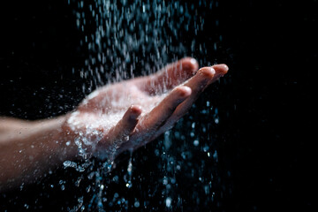 Closeup shot of a human's hand with water flowing onto it