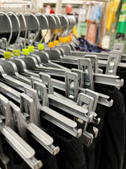 Pants Hangers with Trousers on Rack in Specialty Store