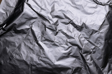 Silver metallic crumpled aluminum foil background