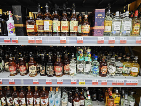 Tequila gin and rum alcohol beverage bottles on a store shelf in a supermarket