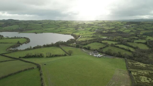 Typical Green-Hued Landscape With River Over County Cavan, Ireland During Sunrise. Aerial Wide Shot