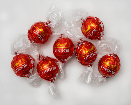 Udine Italy January 3, 2024. group of Lindor chocolates from Lindt on a white background