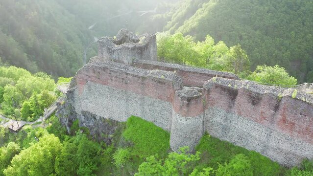Poenari fortress in Romania. Aerial 4k video with this amazing fortress on top of a peak hill from Fagaras Mountains, the place where Vlad Dracula lived. Travel to Romania landmarks. Sunset sky.