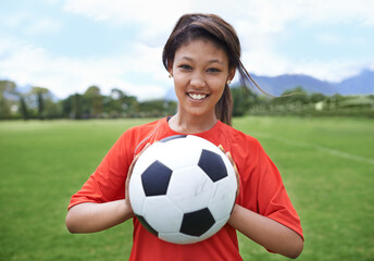 Woman, football field and portrait with ball, happy and soccer player for match, competition and game. Fitness, practice and ready for training, outdoor and exercise for athlete, fun and sport