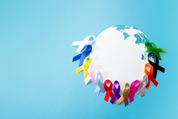 World cancer day concept with world map and many colorful awareness ribbon.Healthcare and medical...
