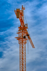 yellow crane against the blue sky