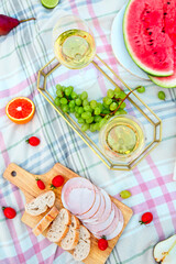 Picnic with white wine on green grass