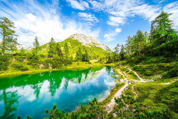 Fairy tale lake on the high plateau of the Tauplitzalm. View of the lake at the Totes Gebirge in Styria. Idyllic landscape with mountains and a lake on the Tauplitz.
