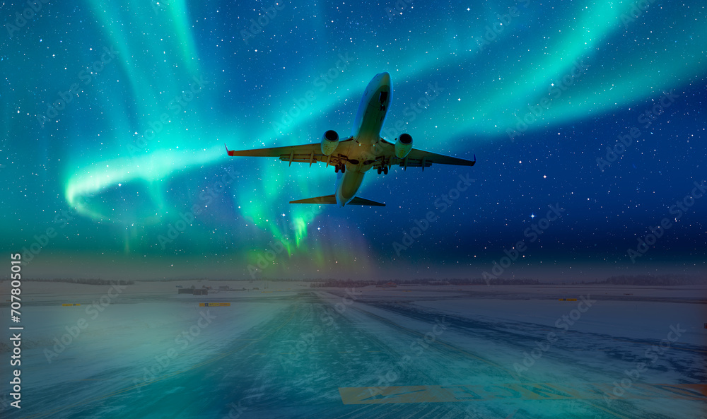 Wall mural Commercical white airplane fly up over take-off runway the (ice) snow-covered airport with aurora borealis - Norway