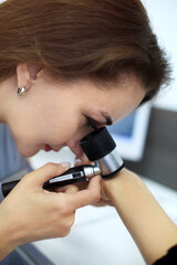 Closeup photo of woman dermatologist examines nevus or birthmarks on patient's hand with dermatoscop