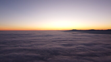 Fototapeta na wymiar Sunset above clouds