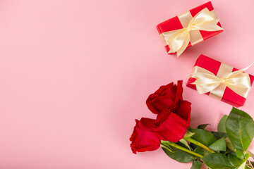 Valentine's Day concept.Valentine's Day background. Gifts and a bouquet of roses on a pink background. Flatley.Valentine's day celebration