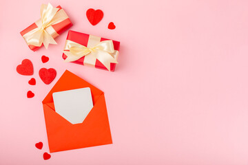 Valentine's Day concept. Valentine's Day background. Gifts, candles, confetti, envelope - postcard on a pink background. Flatley, top view, copy space.Valentine's day celebration