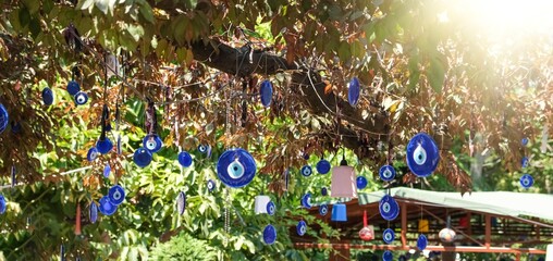 Evil eye beads, Dozens of evil eye beads tied to a tree branch, Turkish culture and the talisman of...
