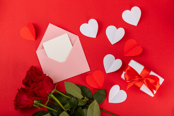 Valentine's Day concept.Valentine's Day background. Gifts, candles, confetti, envelope, candies, glasses, wine and a bouquet of roses on a colored background. Flatley.Valentine's day celebration