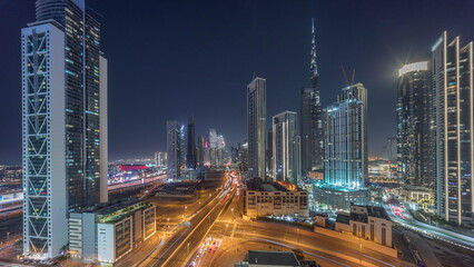 Fototapeta na wymiar Aerial view of Dubai Downtown skyline with many towers night timelapse.