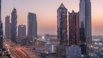 Fototapeta na wymiar Business bay district skyline with modern architecture day to night timelapse from above.