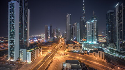 Fototapeta na wymiar Aerial view of Dubai Downtown skyline with many towers all night timelapse.