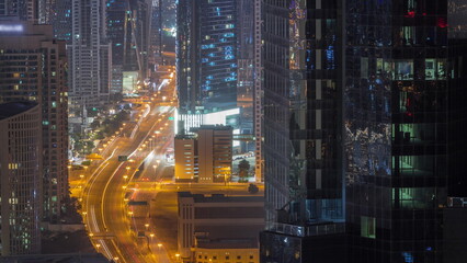 Aerial view from above to a busy road junction in Dubai all night timelapse.