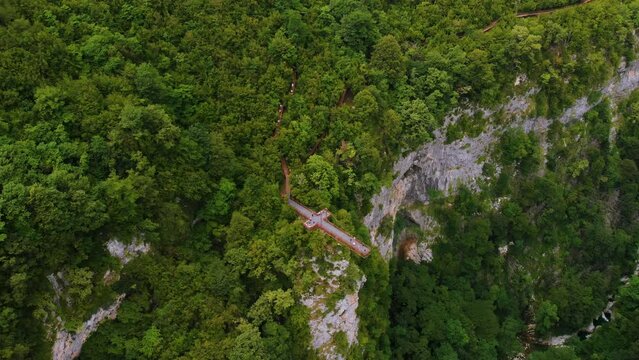 Okace canyon aerial view. The mountains are covered with green forest. Natural landscape. Vacation and Travel. Tourist place in Georgia. metal bridge to explore the area