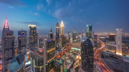 Skyline view of the high-rise buildings on Sheikh Zayed Road in Dubai aerial day to night...