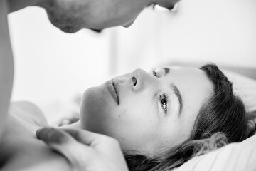 Young passionate couple (two lovers) kissing for intense sex in the bedroom, young tender lover...