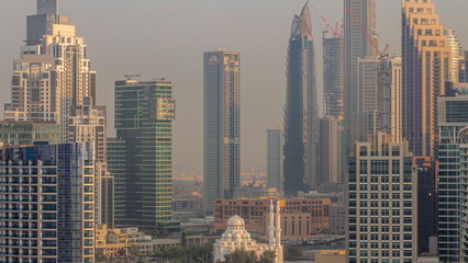 Cityscape with skyscrapers of Dubai Business Bay and water canal aerial morning timelapse.