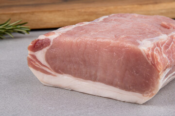 raw pork pig meat loin on grey background with wooden board