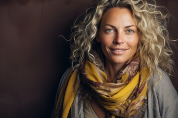 Portrait of a beautiful woman with blond curly hair wearing a scarf